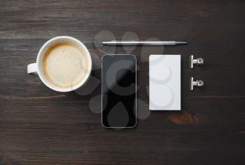 Responsive design template. Coffee cup, smartphone, blank business card and pen on wood table background. Flat lay.
