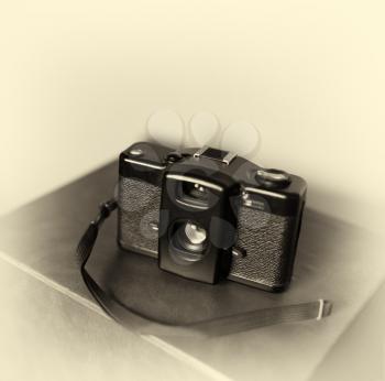 Vintage camera with strap bokeh background