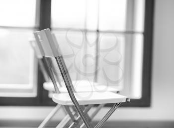 Horizontal black and white office chair bokeh background
