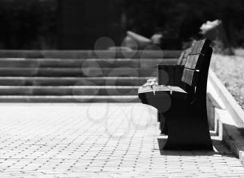 Horizontal black and white right aligned empty bench bokeh background