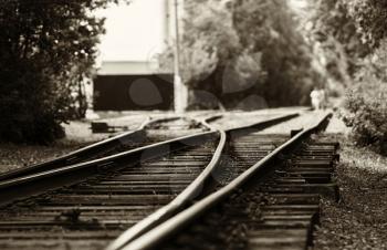 Horizontal black and white sepia railroad track bokeh with people background