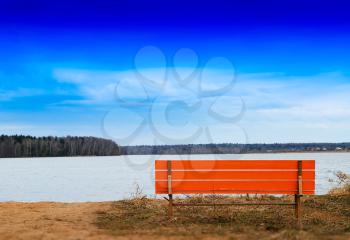 Orange bench on river beach horizon background hd