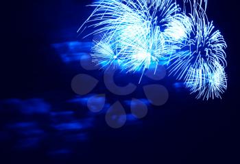 Blue fireworks at night sky background