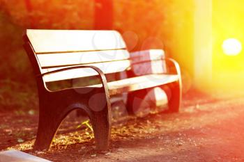 Horizontal sunset park bench in light bokeh background