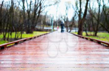 Horizontal wooden path in park bokeh background
