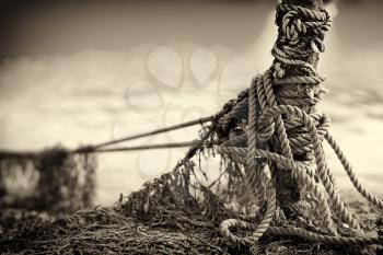 Tied up ship rope on Norway beach in sepia hd