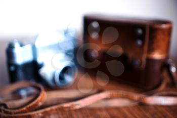 Vintage rangefinder camera with strap and case bokeh background