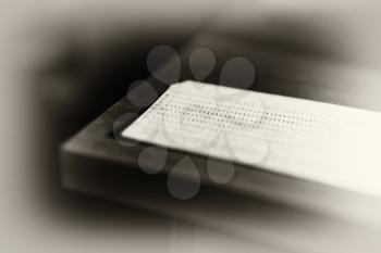 Diagonal punched card in sepia tone background