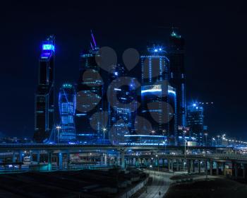 Horizontal vivid blue night Moscow city business center background backdrop