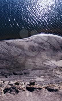 Vertical vibrant sand steep ocean beach background backdrop