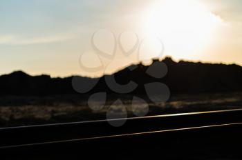 Horizontal vivid colourful railroad track sunset bokeh background backdrop