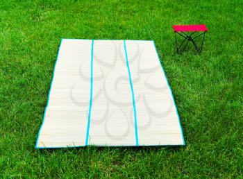 Horizontal vivid bamboo floor mat with chair picnic background