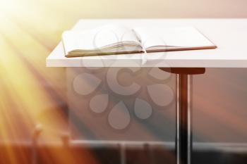 Opened book on table with light leak backdrop hd