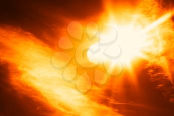 Diagonal orange glowing sun flare with clouds background hd