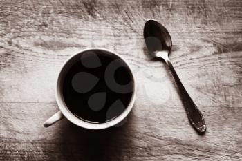 Horizontal cup with spoon bokeh sepia background