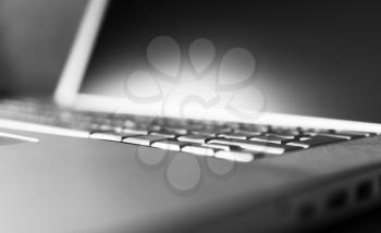 Horizontal black and white laptop keyboard bokeh background
