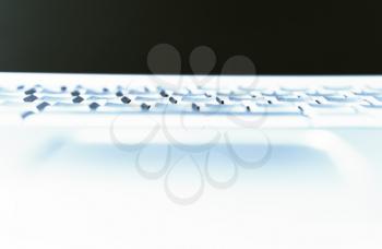 Horizontal cyan laptop keyboard bokeh background
