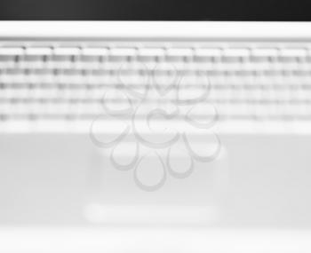 Horizontal black and white  laptop keyboard bokeh background
