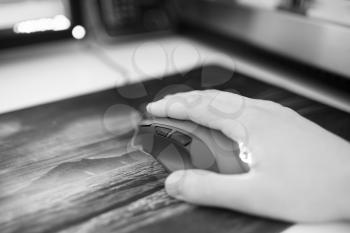 Black and white computer mouse with human hand on mousepad bokeh backdrop hd