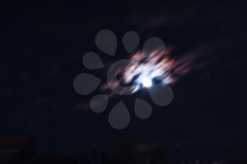 Night clouds in motion and glowing moon background hd