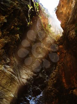 Vertical vivid greece canyon with ray of light dramatic landscape background backdrop