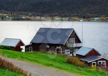 Horizontal vivid Norway house on the bank of the river landscape background backdrop