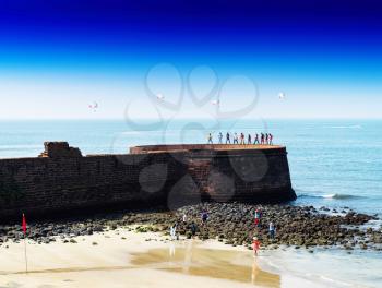 Horizontal vivid Indian castle wall beach with parachutes background