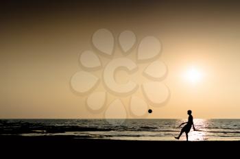 Young man playing football silhouette ocean horizon sunset horizontal illustration