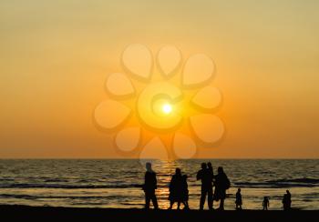 Big family silhouette meeting vivid orange sunset ocean horizon abstraction