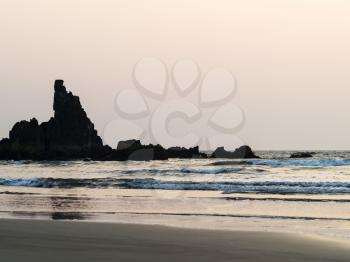 Horizontal dusk ocean rock tidal waves background backdrop