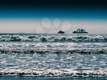 Horizontal vivid two ships in ocean tidal waves horizon background backdrop
