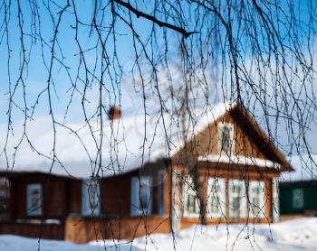 Russian house through tree branches backdrop