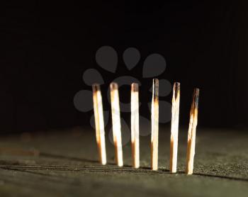 Matches on the table with dramatic lightning background