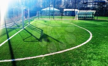 Soccer goal on green field with dramatic shadows background hd