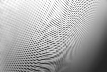 Diagonal carbon hole apertures texture background