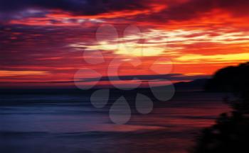 Horizontal vivid red orange vibrant sunset ocean horizon motion abstraction background backdrop