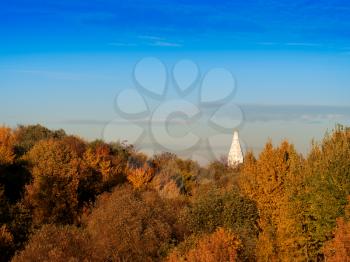 Church tower in autumn landscape background