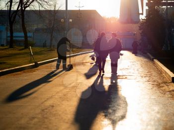 Walking couple at sunny street background