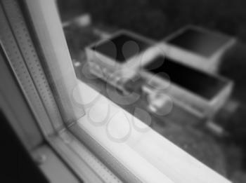 Black and white window border view on city roofs bokeh background