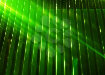 Diagonal light rays falling on green fence object background
