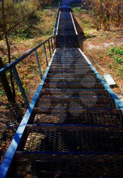 Vertical stairs to autumn park landscape background
