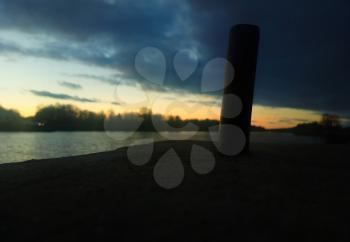 Simple geometric object during river sunset background
