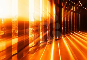 Dramatic light rays though vetical columns background