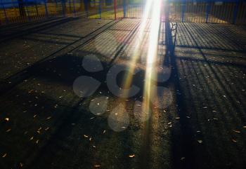 Dramatic light rays on sport playground background