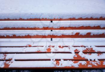 Park bench in snow winter background