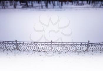 Clean park poind in snow with bottom aligned fence background
