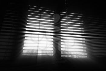 Diagonal office blinds with dramatic rays background