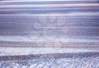 Snow on the winter road with wheel traces background