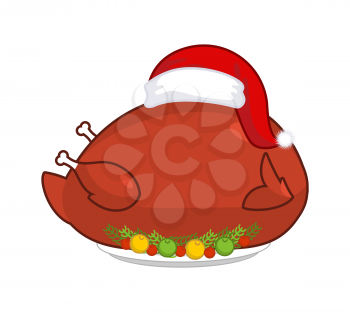 Big Roast turkey in Santa Claus cap. Christmas fowl on plate with vegetables. Fried chicken in festive red hat. holiday food for new year
