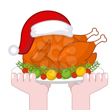 Christmas turkey in Santa Claus cap. Roast fowl on plate with vegetables. Fried chicken in festive red hat. holiday food for new year
